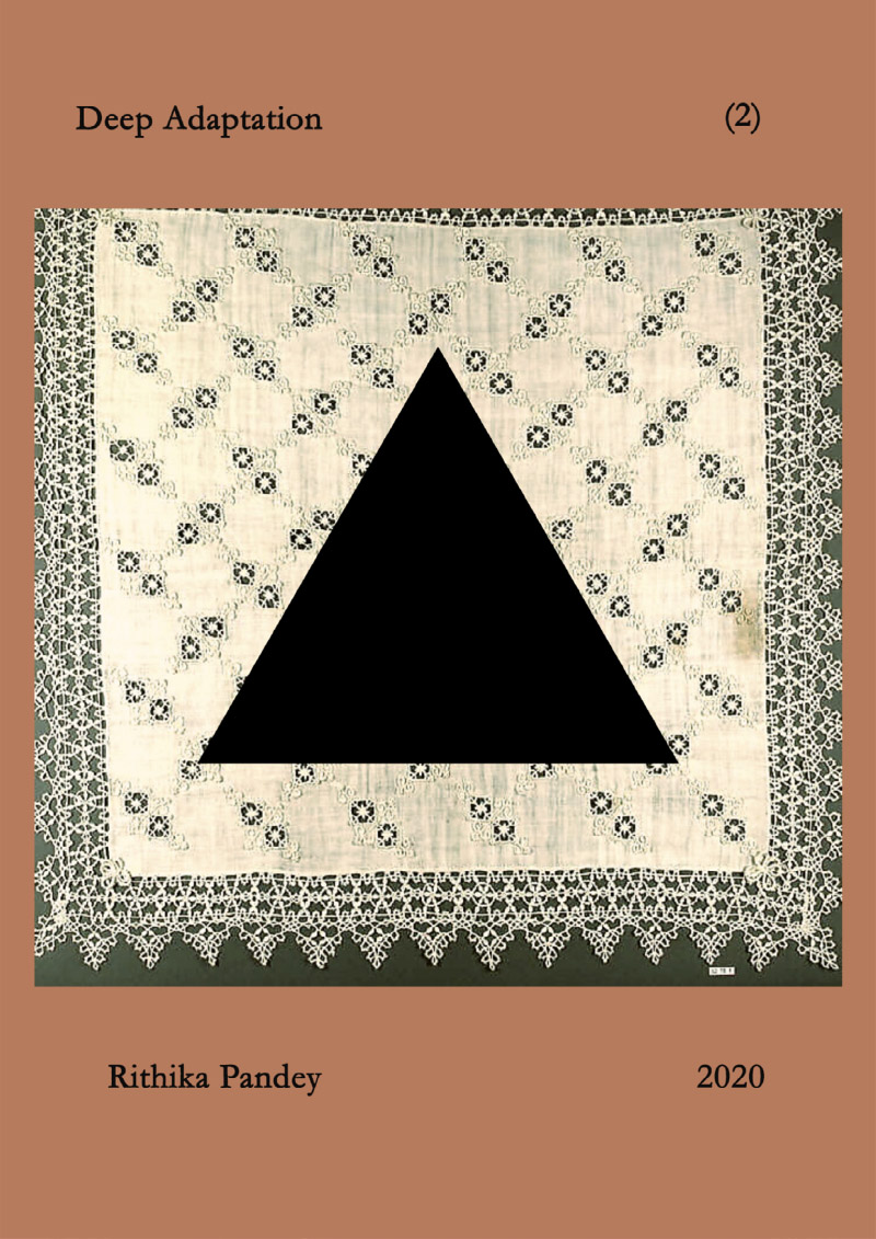 Brown zine front page with a photo of an embroidered doily on top with a black square on top of that